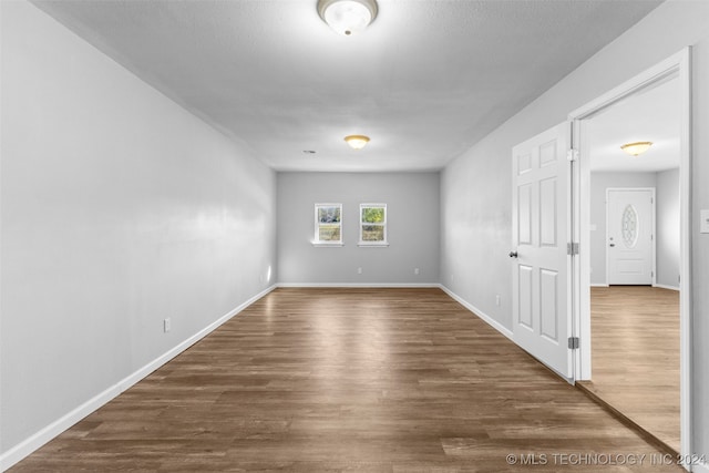 unfurnished room with dark hardwood / wood-style floors