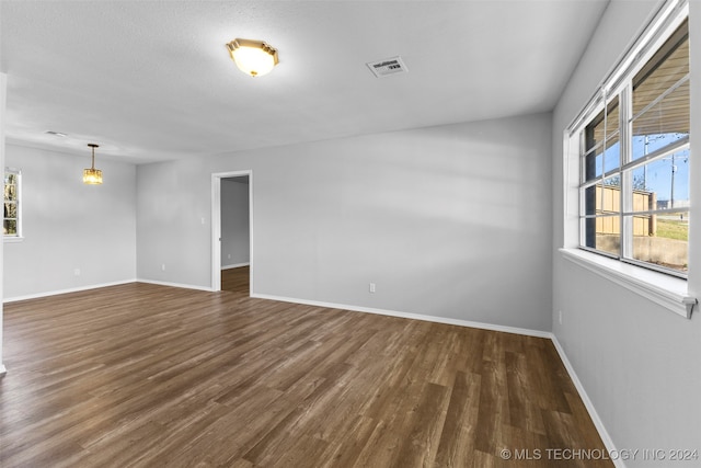 unfurnished room with dark hardwood / wood-style floors