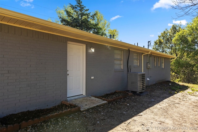 property entrance featuring central AC unit