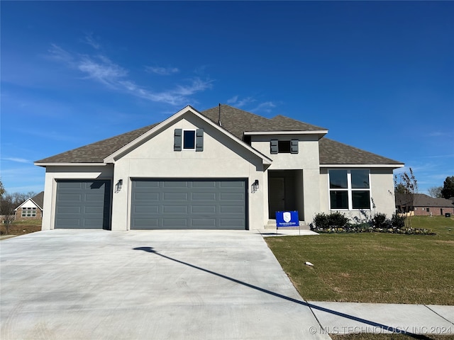 view of front facade with a garage and a front yard