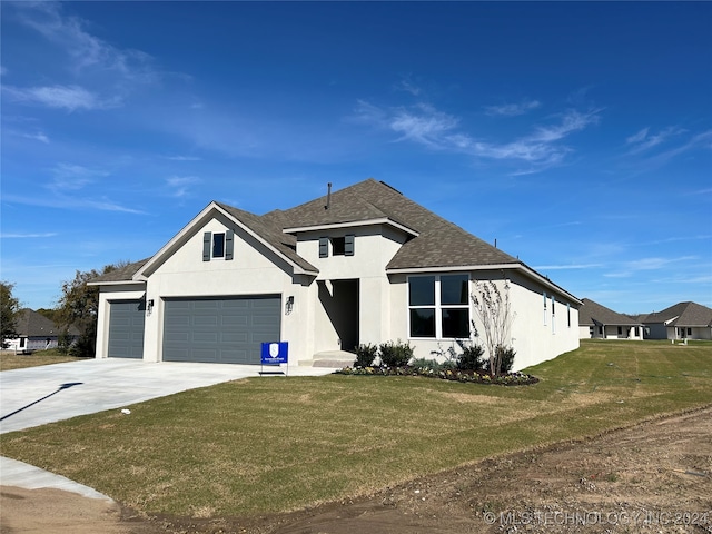 view of front of home with a front lawn and a garage