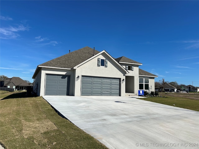 view of front facade with a front yard and a garage