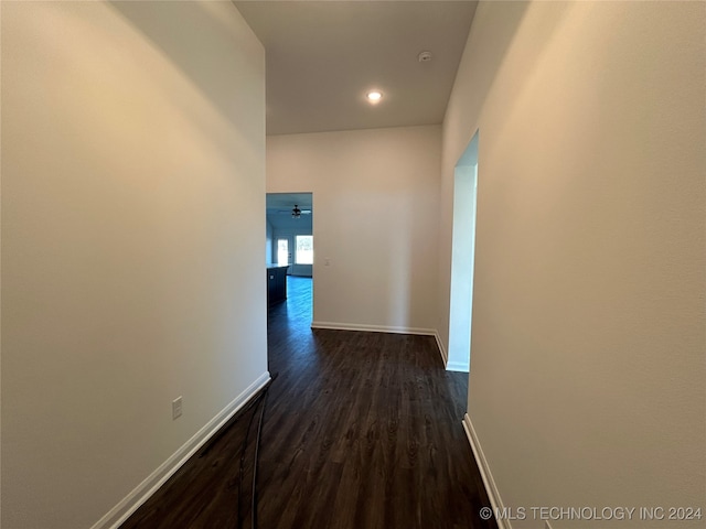 corridor with dark hardwood / wood-style flooring