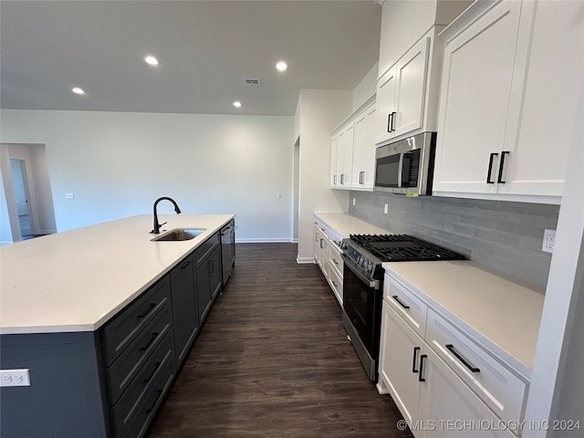 kitchen featuring stainless steel appliances, dark hardwood / wood-style flooring, a center island with sink, sink, and white cabinetry