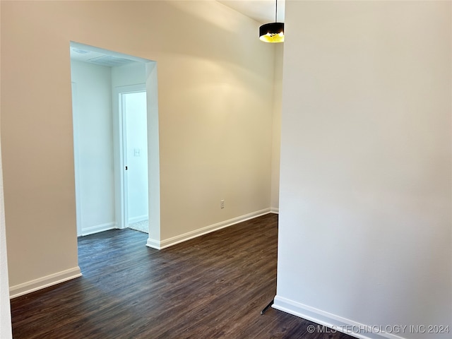 unfurnished room with dark hardwood / wood-style floors