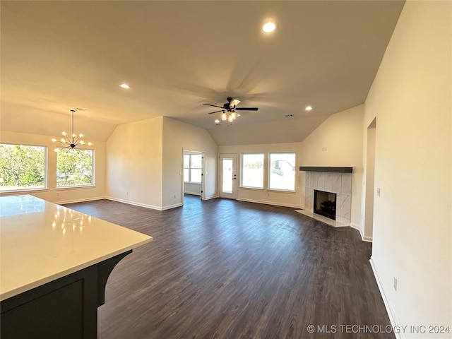 unfurnished living room featuring dark wood-type flooring, a healthy amount of sunlight, and lofted ceiling