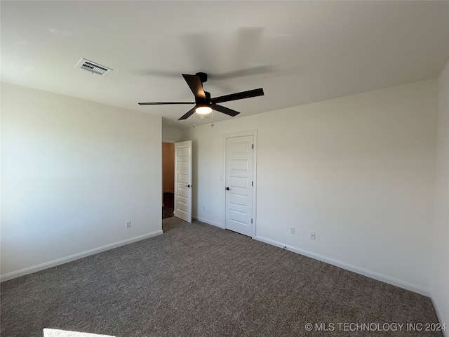 unfurnished bedroom featuring ceiling fan, a closet, and dark carpet