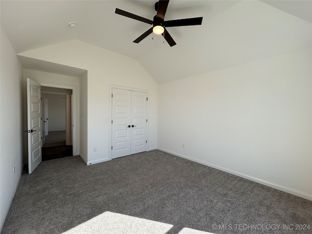 unfurnished bedroom with a closet, lofted ceiling, carpet flooring, and ceiling fan