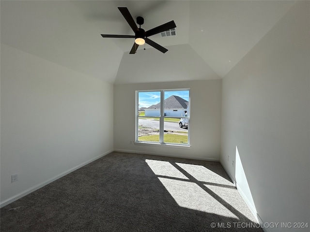 carpeted spare room with ceiling fan and vaulted ceiling