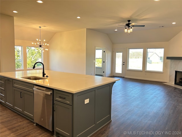 kitchen featuring a center island with sink, gray cabinets, hanging light fixtures, sink, and dishwasher