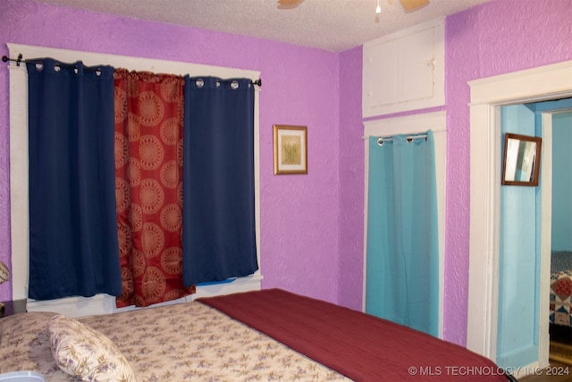 bedroom featuring a textured ceiling and ceiling fan