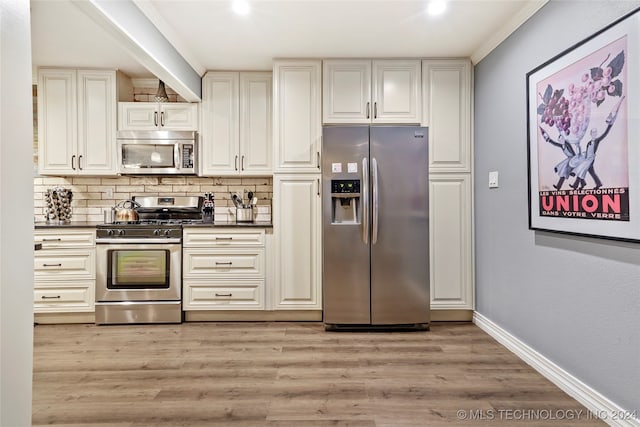 kitchen featuring stainless steel appliances, light hardwood / wood-style floors, ornamental molding, and tasteful backsplash