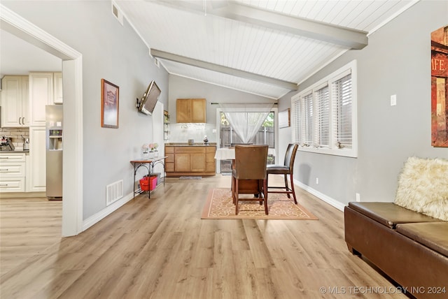 dining room with light hardwood / wood-style floors, vaulted ceiling with beams, and wood ceiling