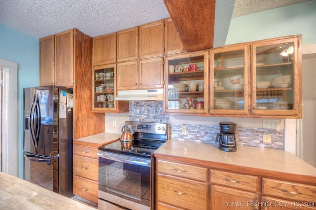 15705 Old Morris Hwy, Okmulgee, OK 74447 - kitchen featuring fridge with ice dispenser, stainless steel electric range, under cabinet range hood, light countertops, and decorative backsplash
