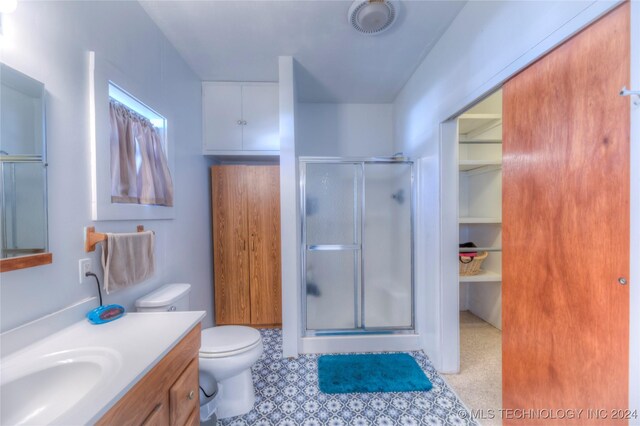 15705 Old Morris Hwy, Okmulgee, OK 74447 - bathroom with a stall shower, vanity, and toilet