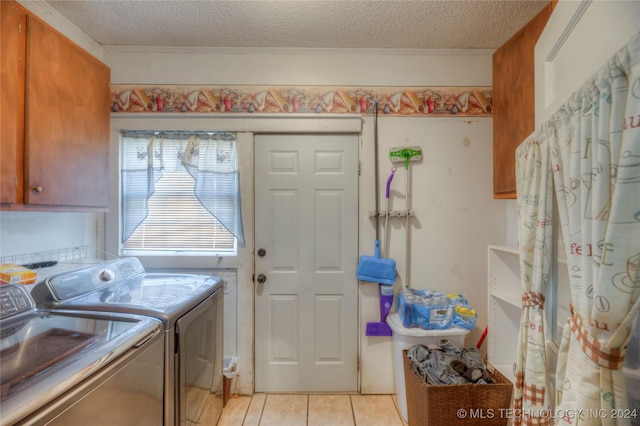 15705 Old Morris Hwy, Okmulgee, OK 74447 - laundry room with washer and clothes dryer, cabinet space, light tile patterned floors, a textured ceiling, and crown molding