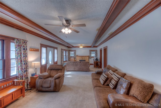 carpeted living room featuring a textured ceiling, ceiling fan, and crown molding