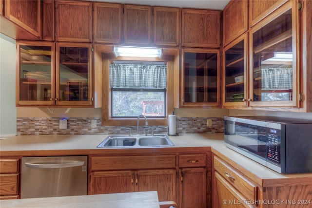 15705 Old Morris Hwy, Okmulgee, OK 74447 - kitchen featuring stainless steel appliances, a sink, light countertops, and glass insert cabinets