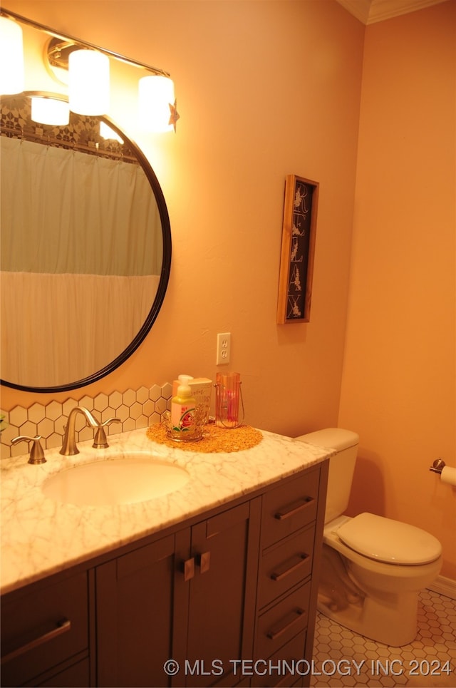 bathroom featuring ornamental molding, vanity, tile patterned floors, and toilet