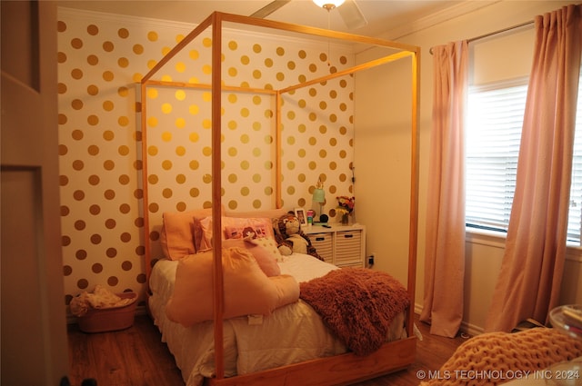 bedroom featuring ornamental molding, wood-type flooring, and ceiling fan