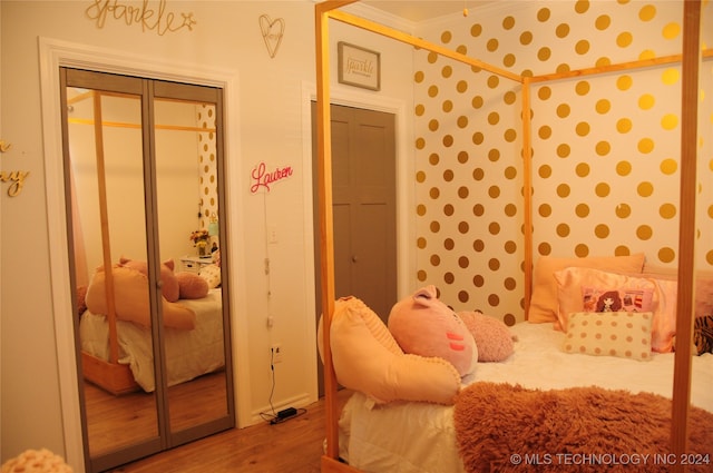 bedroom featuring a closet and hardwood / wood-style flooring