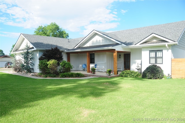 view of front of property with covered porch and a front lawn