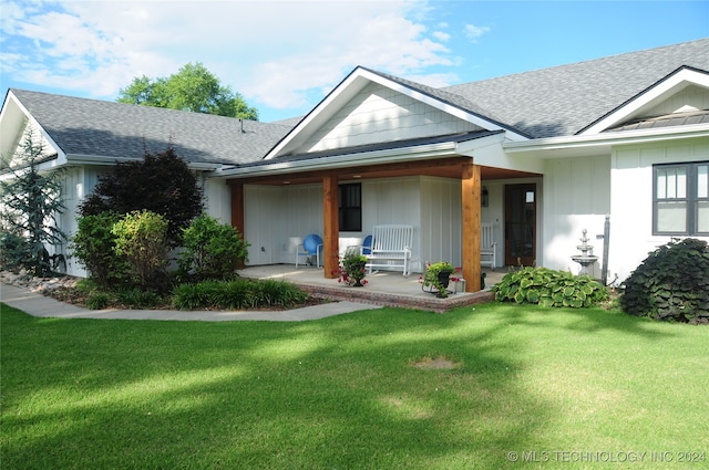 view of front of property with covered porch and a front yard