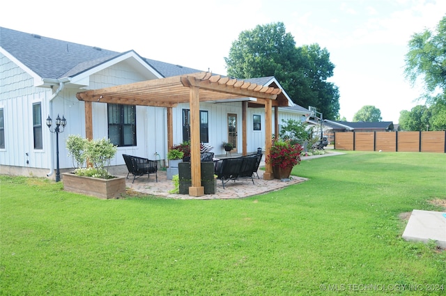 back of property with a patio area, a pergola, and a yard