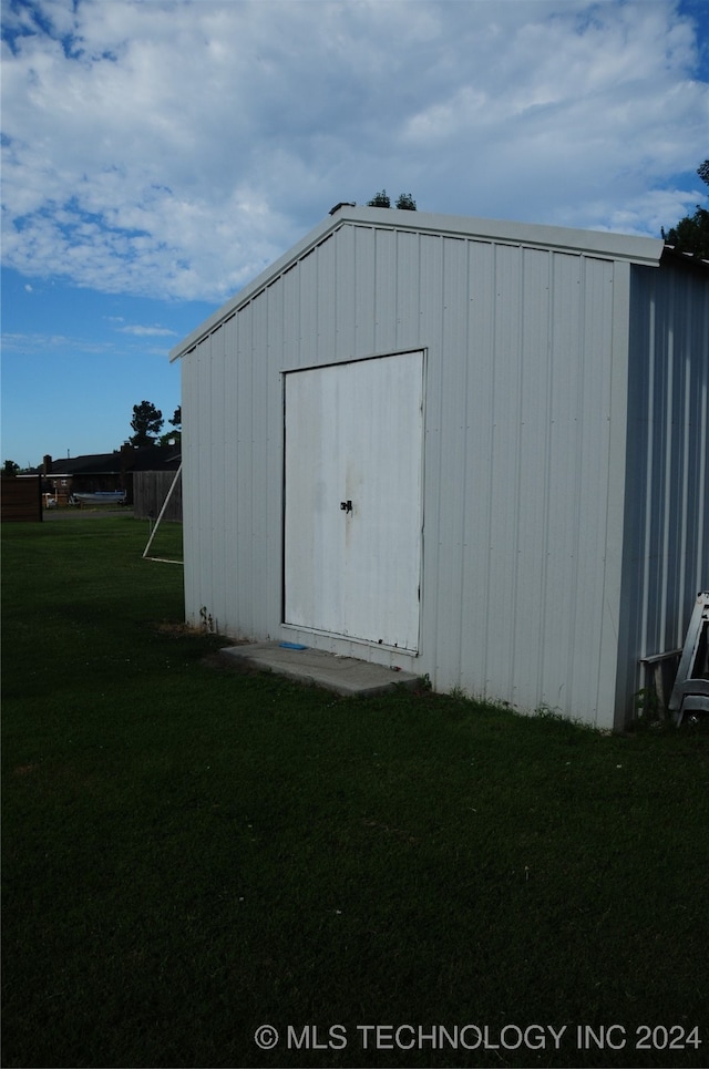 view of outbuilding featuring a yard