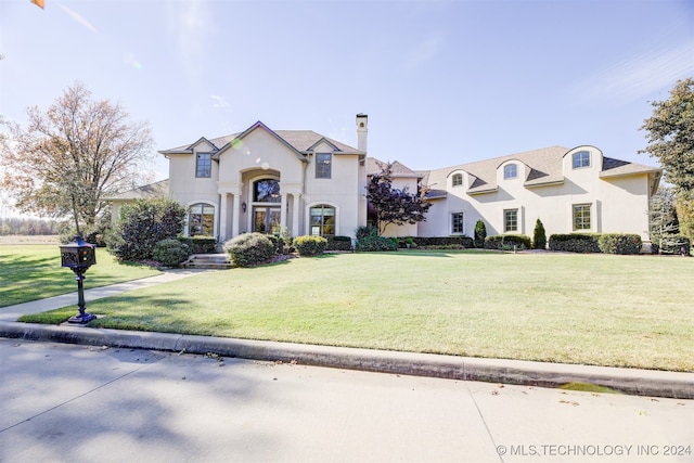 french provincial home featuring a front lawn