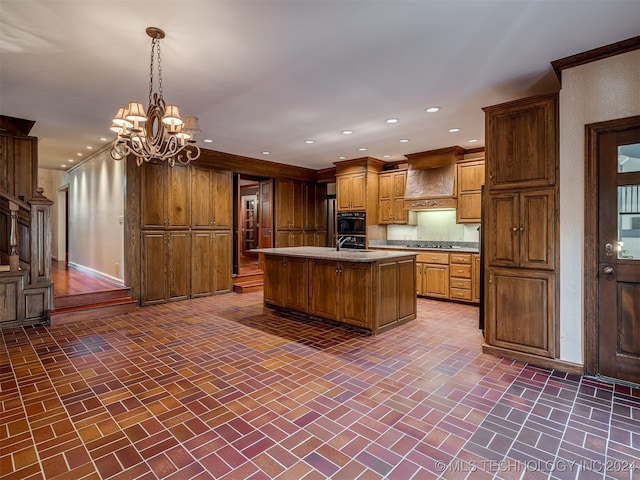 kitchen with hanging light fixtures, premium range hood, a chandelier, a kitchen island with sink, and black appliances