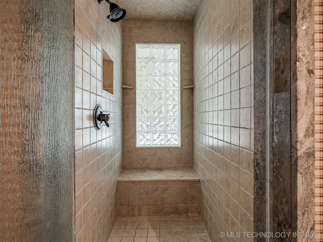 bathroom with a tile shower