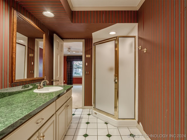 bathroom featuring vanity, ceiling fan, crown molding, and walk in shower