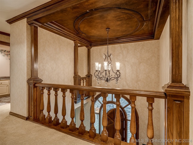 staircase featuring carpet, a notable chandelier, crown molding, and a tray ceiling