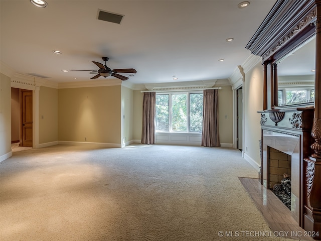 unfurnished living room with crown molding, a fireplace, ceiling fan, and a healthy amount of sunlight