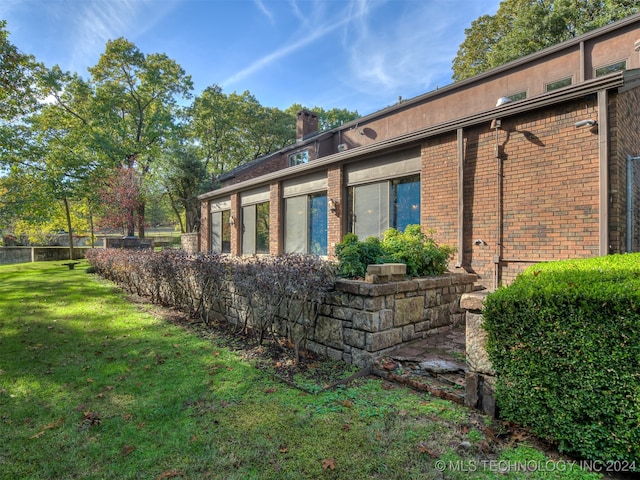 view of home's exterior with a yard