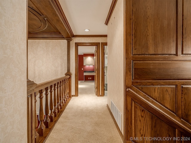 corridor with light carpet, beamed ceiling, and ornamental molding