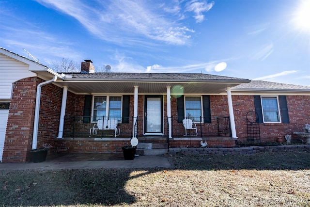 815 S Oak Grove Rd, Cushing, OK 74023 - ranch-style home featuring a porch, a chimney, and brick siding