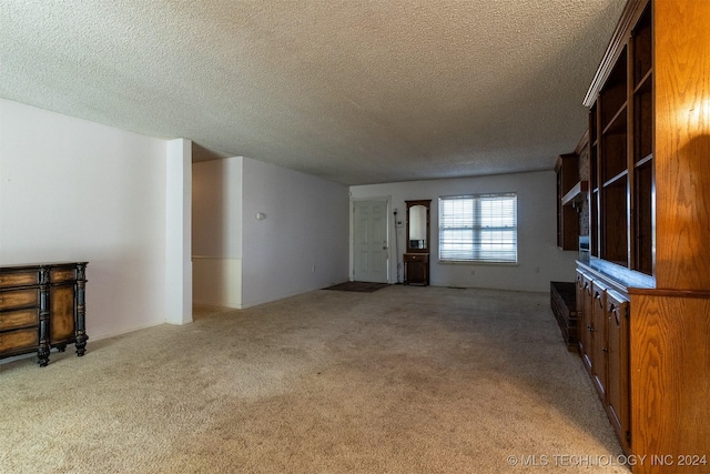 815 S Oak Grove Rd, Cushing, OK 74023 - unfurnished living room with carpet floors and a textured ceiling