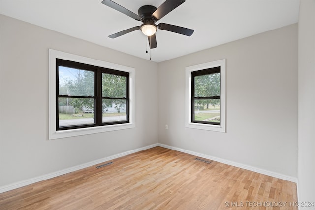 spare room with ceiling fan and light wood-type flooring