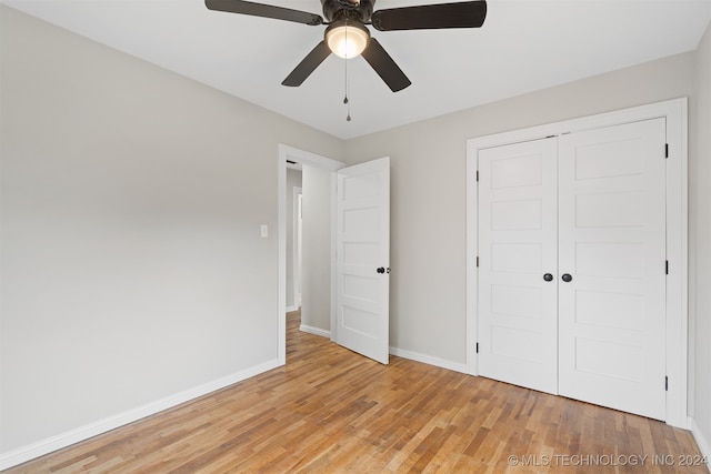 unfurnished bedroom with ceiling fan, light hardwood / wood-style flooring, and a closet