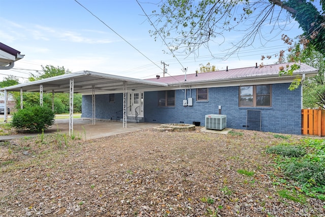 rear view of house with central AC unit