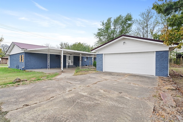 single story home featuring an outbuilding, a porch, and a garage