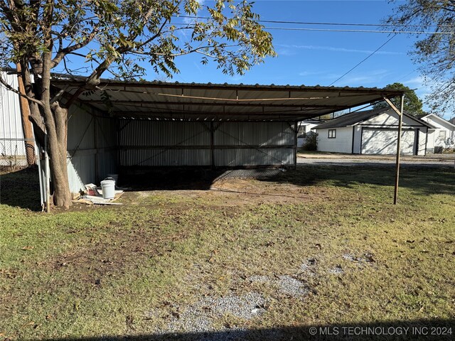 exterior space with a lawn and a carport