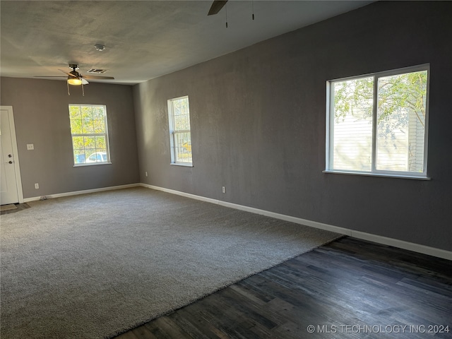 spare room featuring dark wood-type flooring and ceiling fan