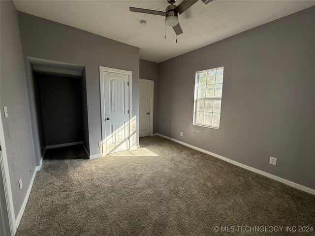 unfurnished bedroom featuring ceiling fan, carpet flooring, and a closet