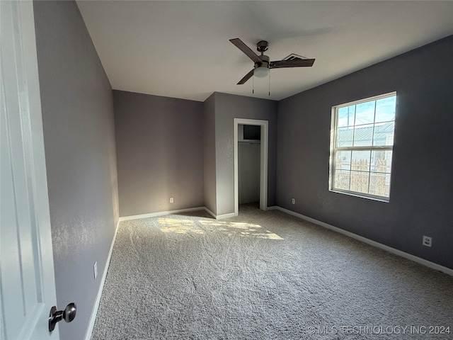 unfurnished bedroom featuring a closet, carpet flooring, and ceiling fan