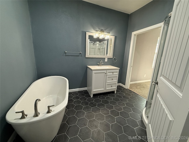 bathroom featuring vanity, tile patterned flooring, and a bathing tub
