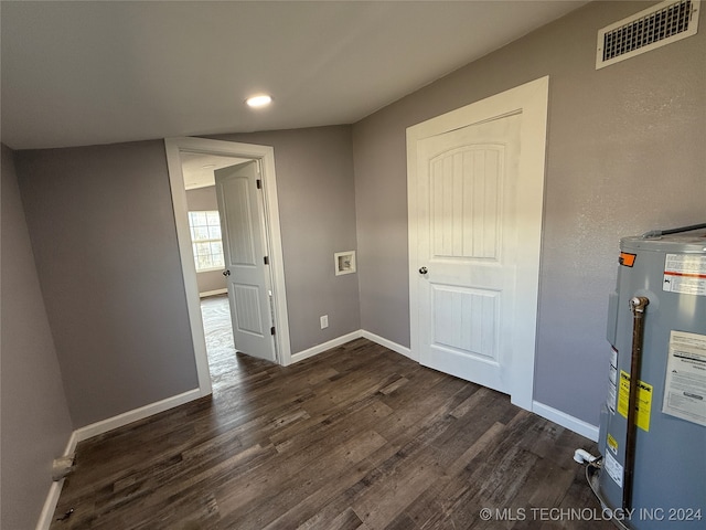 interior space featuring electric water heater and dark hardwood / wood-style floors