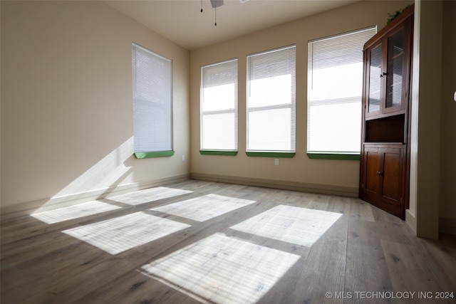 spare room with light wood-type flooring and ceiling fan